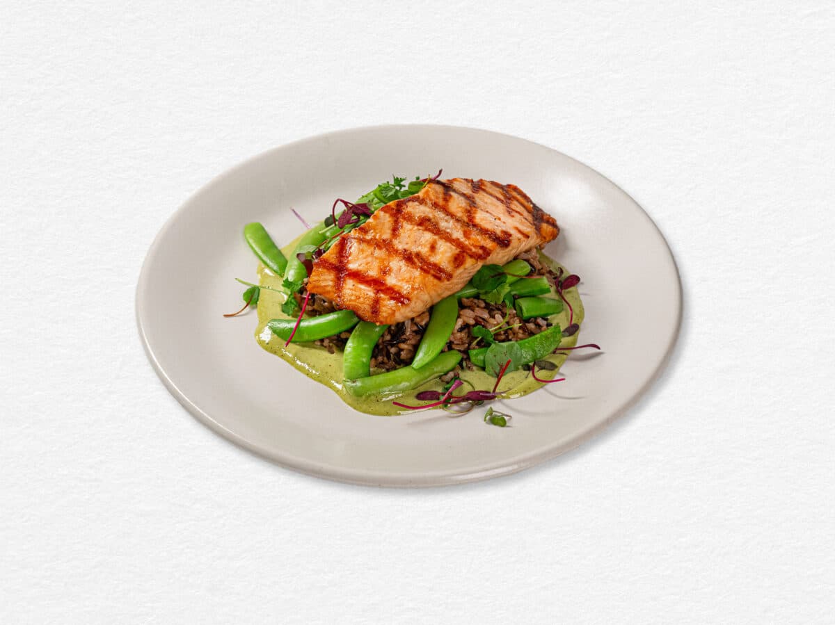 True Food Kitchen grilled sustainable salmon with snap peas, grains, and herb sauce.