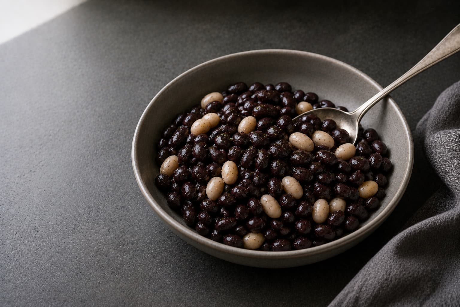 Black, pinto, kidney, and cannellini beans in separate bowls